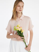 A lady wears a silk shirt.